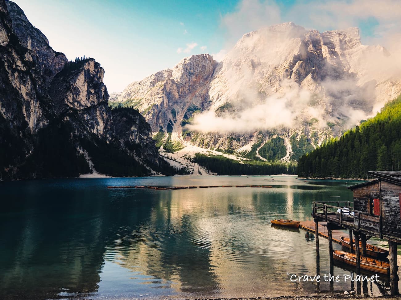 Lago di Braies, also known as the "Pearl of the Dolomites," is a stunning gem nestled in the heart of the Dolomites in Italy. As someone who has visited with my family for the past three summers to hike the Alta Via 1, I can attest that it is definitely worth a visit. But getting to Lago di Braies can be challenging in high season. It is easily accessible by car from nearby towns such as Cortina d'Ampezzo, Bolzano, and Innsbruck, but hard to park. It is located in the province of South Tyrol and is well connected to major roads. In summer, the roads are closed for most of the day, and it is essential to have pre-paid parking booked online between July 10th and September 10th if you drive between 9:00 am - 4:00 pm. The Lago di Braies Nature Park area offers a variety of hiking trails for all levels. You can take a romantic hike and explore the beautiful alpine scenery, the lakeside chapel, and easy hiking paths. You can also take a handcrafted wooden boat ride on the crystal-clear waters of Lake Braies and enjoy the stunning views of the surrounding mountains. For a fantastic and seriously challenging day hike, you can go to a high elevation mountain hut called "Rifugio Biella" or "Seekofel hütte." There may be other names for it, but these are the two most popular ones you'll see on Google maps. The best place to stay for a romantic getaway is the Hotel Lago di Braies directly on the lake. The hotel offers comfortable rooms with stunning views of the lake and the surrounding mountains. You can enjoy a candlelit dinner at the hotel's restaurant, which serves delicious local cuisine. The hotel also offers spa services, making it the perfect place for couples to relax and unwind after a day of hiking and exploring the beautiful surroundings.